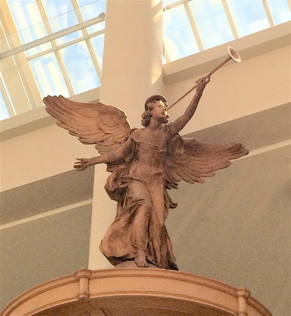 Carved angel from all angels church located atop pulpit on display in Metropolitan Museum of Art in New York City